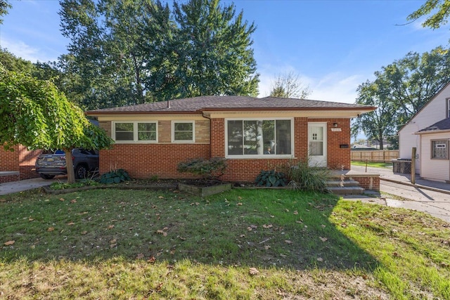 view of front of house with brick siding and a front lawn