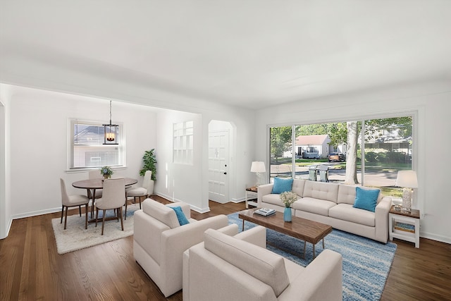 living area featuring dark wood-style flooring and baseboards