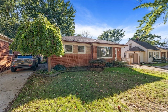 view of front facade featuring a front yard and brick siding