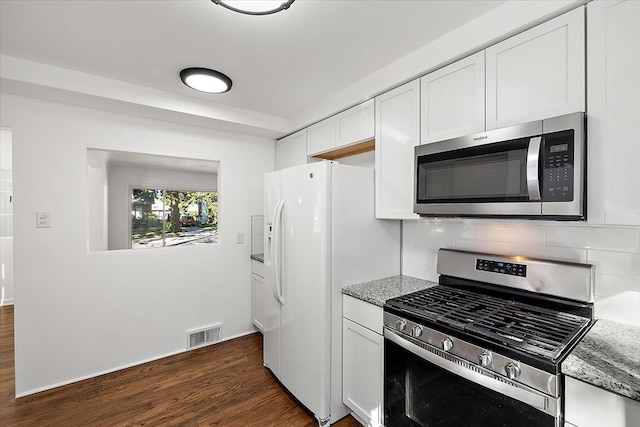 kitchen featuring visible vents, appliances with stainless steel finishes, light stone countertops, white cabinetry, and backsplash