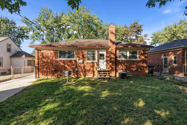 view of front facade featuring entry steps, brick siding, a chimney, and fence