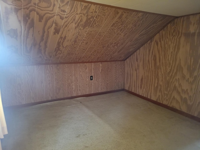 additional living space featuring lofted ceiling and baseboards