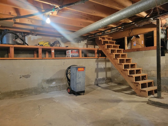 unfinished basement featuring stairs