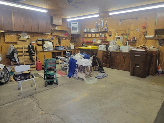 garage with ceiling fan and a workshop area