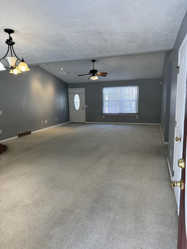 interior space with baseboards, a textured ceiling, visible vents, and carpet flooring