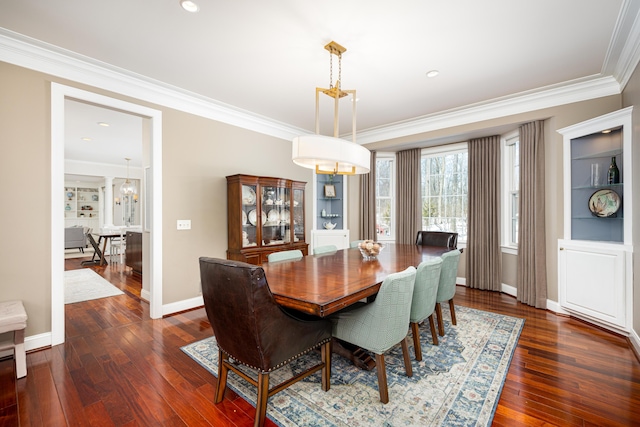 dining room with ornamental molding, dark wood-style flooring, and baseboards