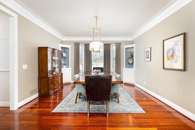 dining space with crown molding, dark wood finished floors, visible vents, and baseboards