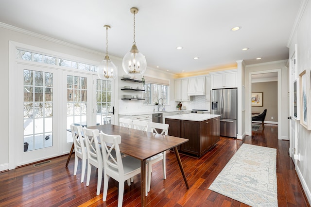 dining space with dark wood-style floors, recessed lighting, visible vents, and ornamental molding