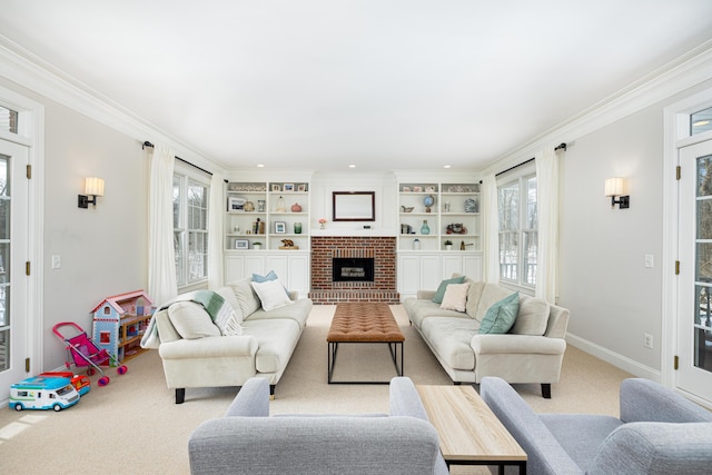 living room featuring carpet floors, a brick fireplace, crown molding, and baseboards