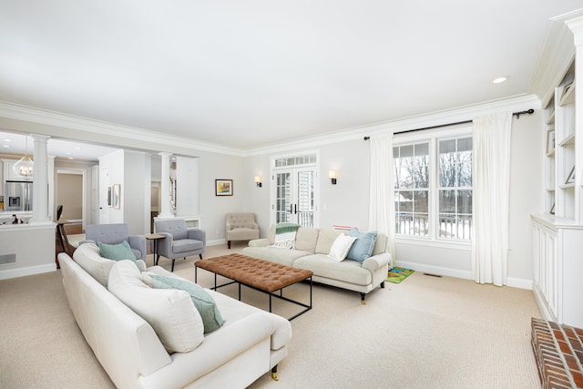 living area with light carpet, ornate columns, baseboards, and crown molding