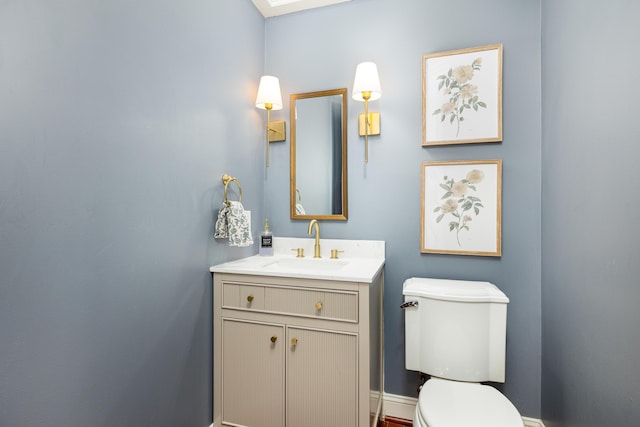 bathroom with toilet and vanity