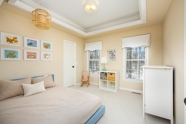 bedroom featuring light colored carpet, a raised ceiling, visible vents, and baseboards