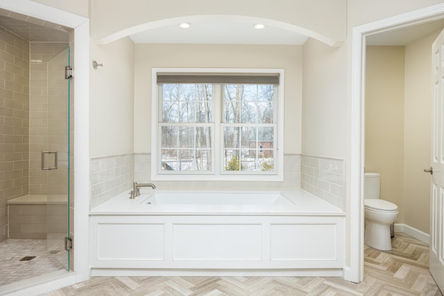 full bath featuring a stall shower, recessed lighting, toilet, and a bath