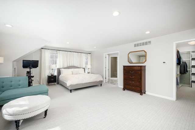 bedroom featuring recessed lighting, light carpet, visible vents, baseboards, and a spacious closet