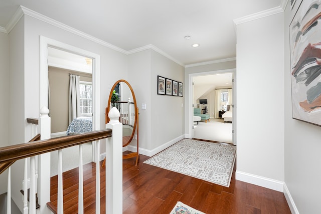 hall with baseboards, dark wood finished floors, and crown molding