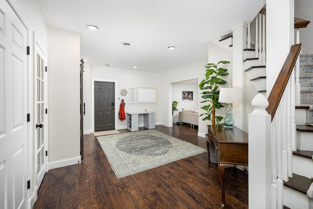 entrance foyer featuring stairs, dark wood-style flooring, recessed lighting, and baseboards