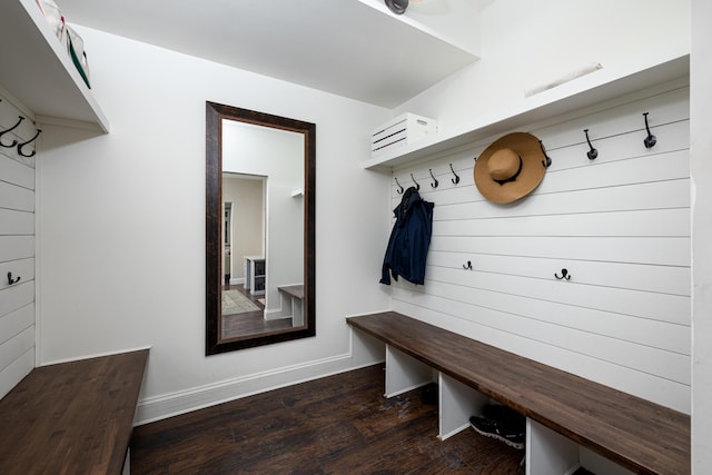 mudroom with dark wood-style floors and baseboards