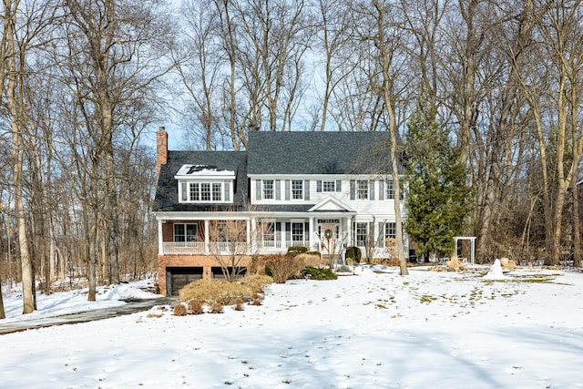 colonial home with a garage and a chimney