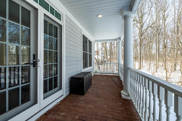 view of snow covered back of property