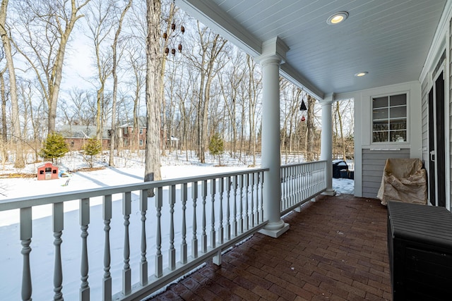 view of snow covered back of property