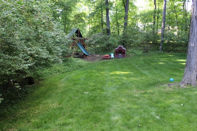 view of yard with a shed and a playground