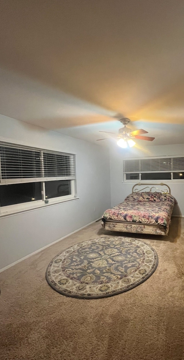 carpeted bedroom with a ceiling fan