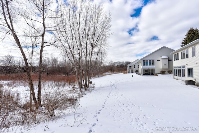 yard layered in snow with cooling unit