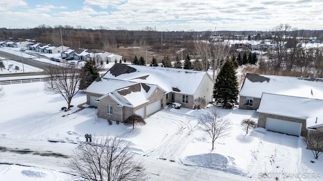 snowy aerial view featuring a residential view