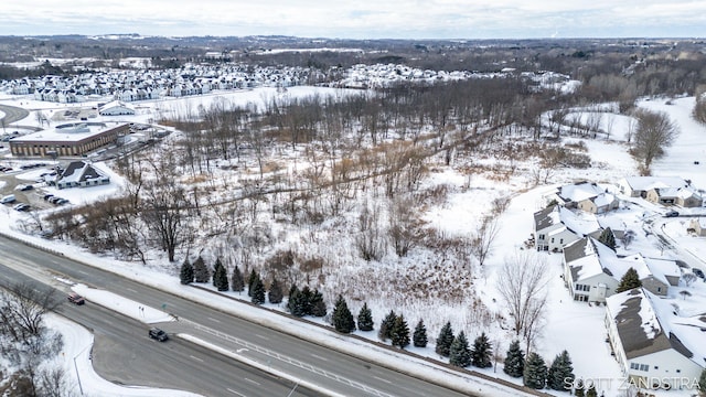 snowy aerial view with a residential view