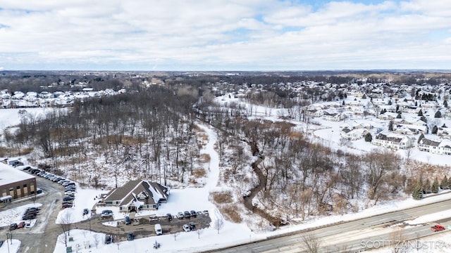 snowy aerial view with a residential view