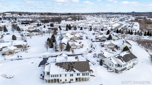 snowy aerial view featuring a residential view