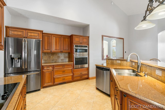 kitchen with decorative light fixtures, light tile patterned floors, tasteful backsplash, appliances with stainless steel finishes, and a sink