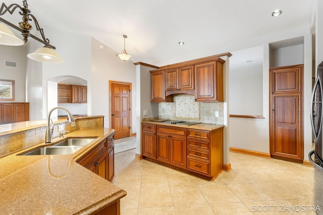 kitchen with visible vents, pendant lighting, light countertops, and a sink