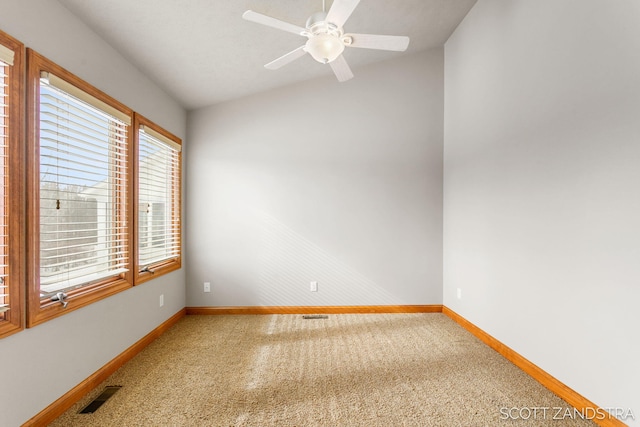 unfurnished room featuring baseboards, visible vents, lofted ceiling, ceiling fan, and carpet floors