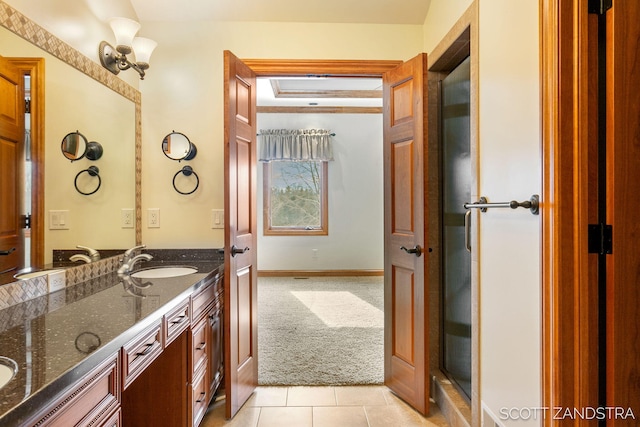 full bath featuring tile patterned flooring, baseboards, and vanity