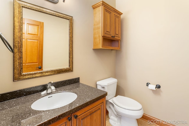 bathroom featuring toilet and vanity