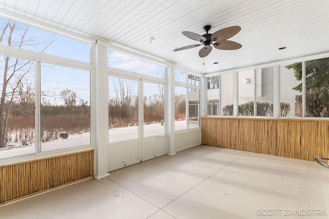 unfurnished sunroom with a ceiling fan