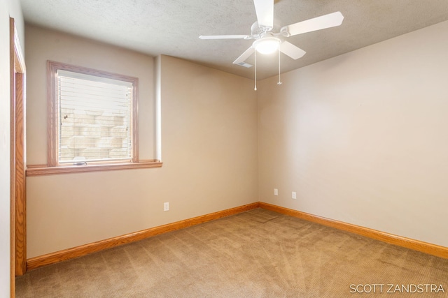 unfurnished room with a textured ceiling, ceiling fan, carpet, and baseboards