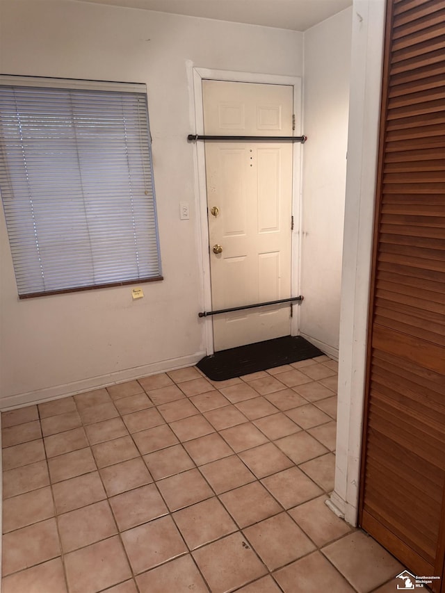 doorway featuring baseboards