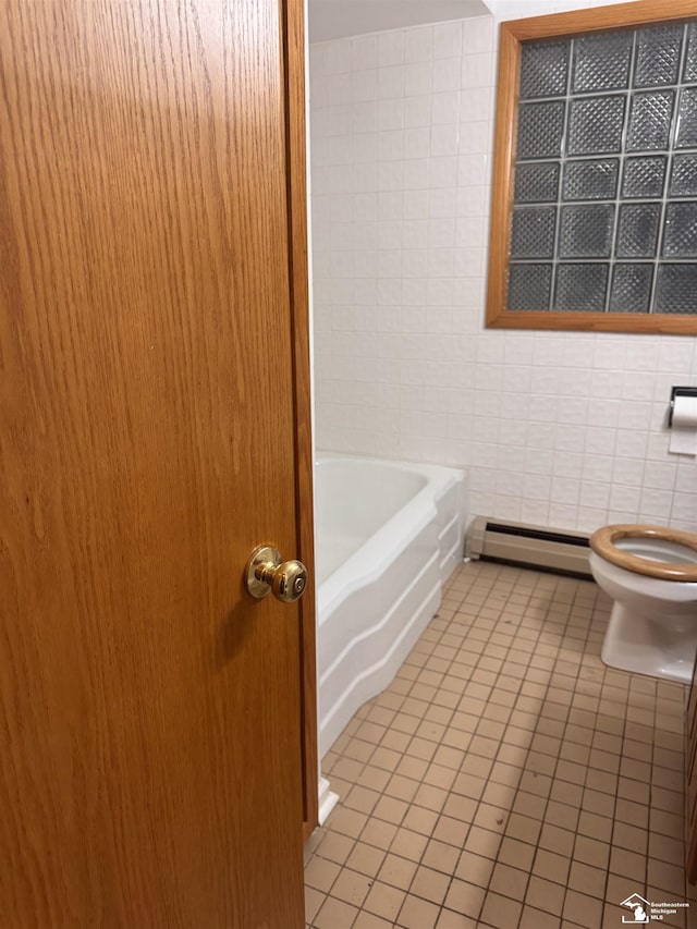 bathroom with tile patterned flooring, toilet, and baseboard heating