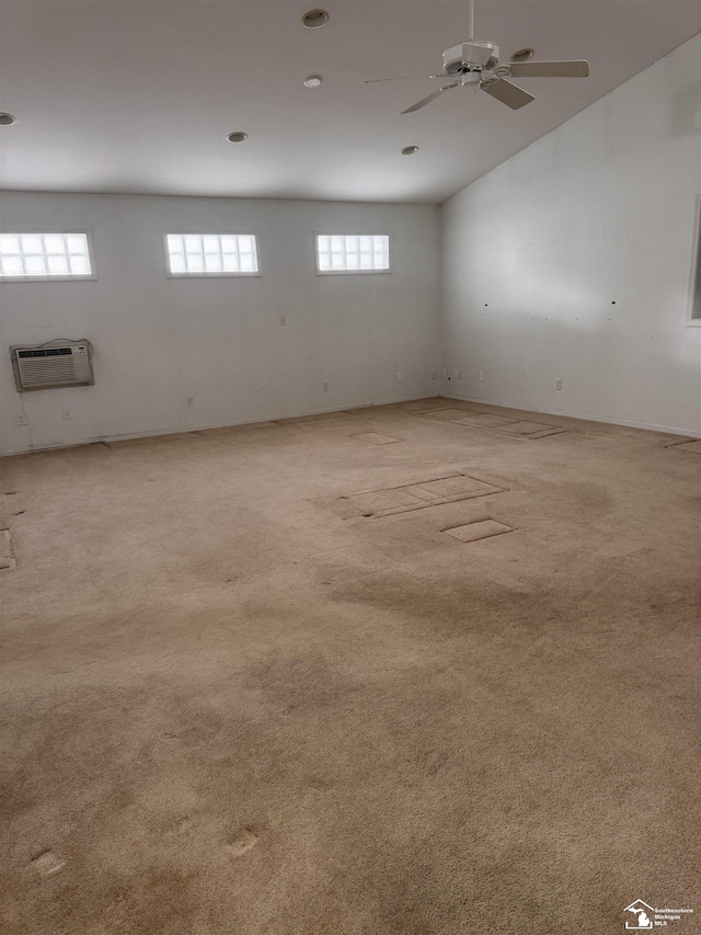 unfurnished room featuring a wall mounted air conditioner, a ceiling fan, and light colored carpet