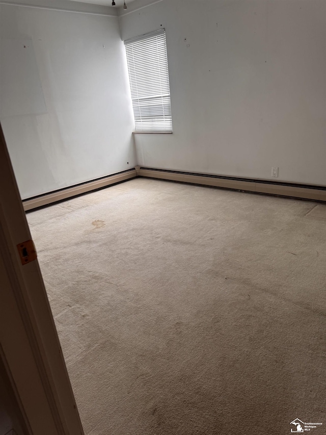 spare room featuring light colored carpet