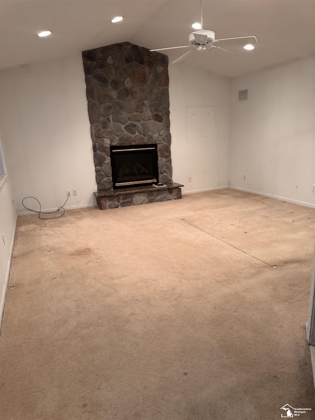 unfurnished living room with ceiling fan, recessed lighting, a fireplace, vaulted ceiling, and carpet