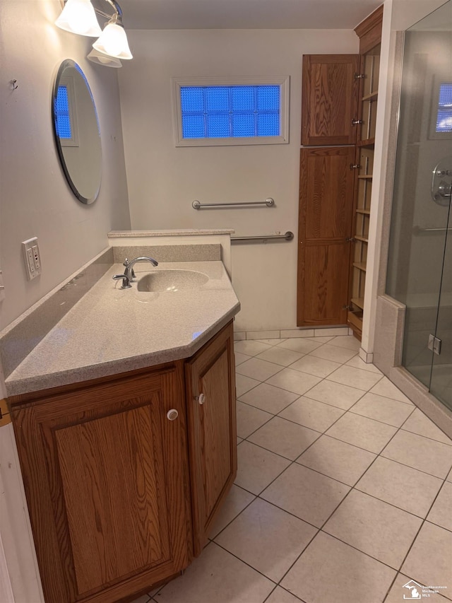 full bathroom featuring a stall shower, vanity, and tile patterned floors