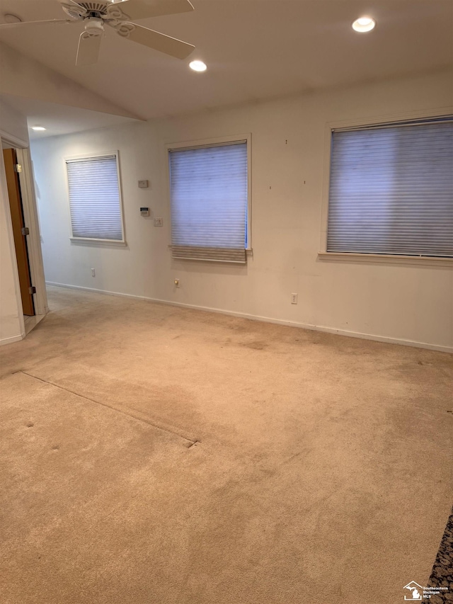 empty room featuring light carpet, baseboards, a ceiling fan, and recessed lighting