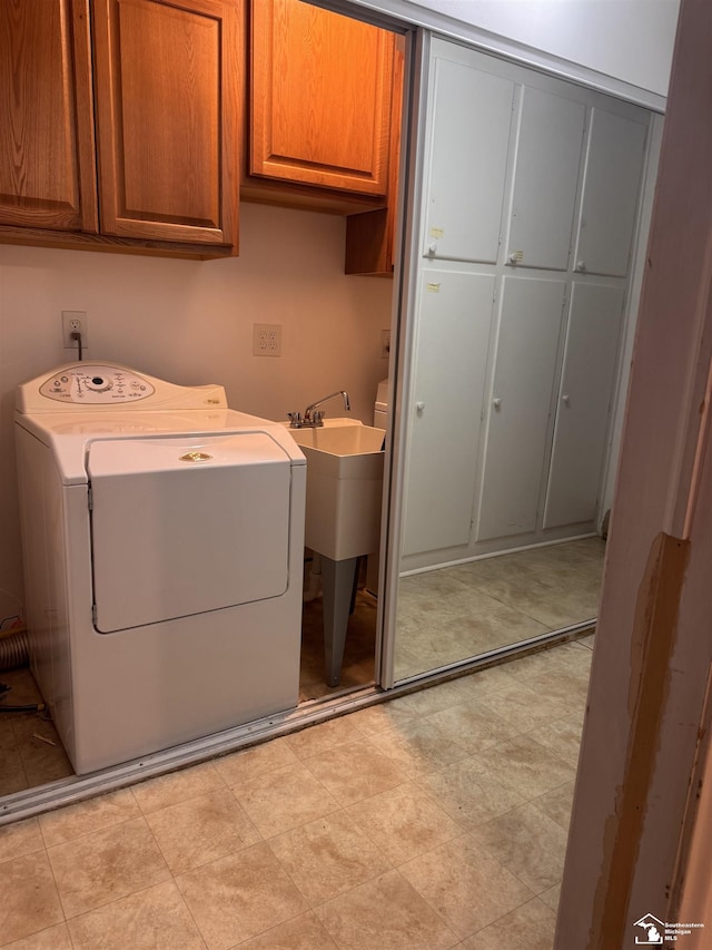 washroom featuring washer / clothes dryer and cabinet space