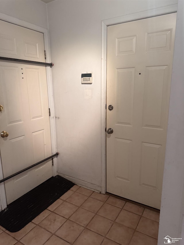 doorway to outside with light tile patterned floors