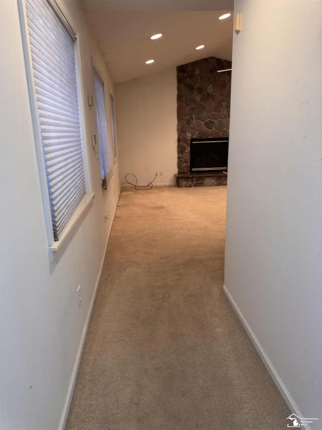 hall with light carpet, vaulted ceiling, baseboards, and recessed lighting