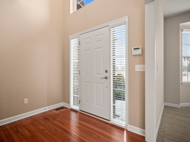 entrance foyer featuring baseboards and hardwood / wood-style floors