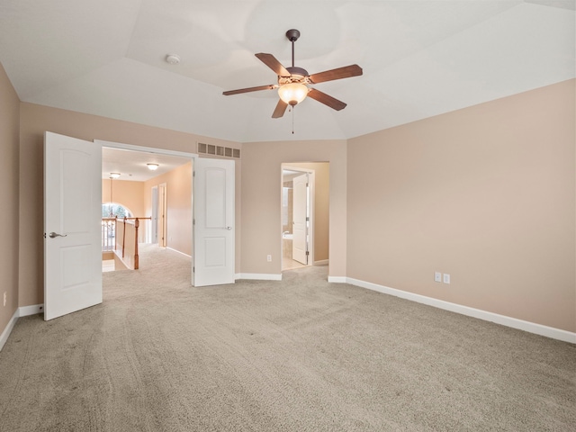 unfurnished bedroom featuring visible vents, connected bathroom, baseboards, ceiling fan, and light colored carpet